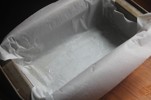 line loaf pan with parchment paper for making palm jaggery cake